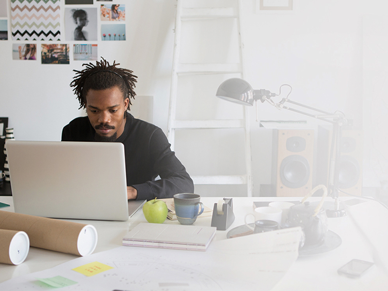 Young African architect working at his studio.